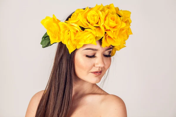 Modelo en un vestido amarillo y una hermosa corona en su cabeza — Foto de Stock