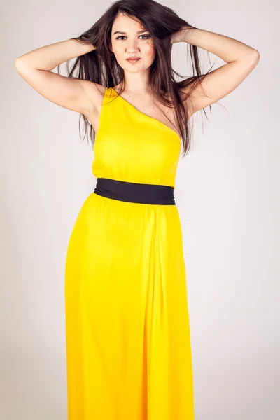 Model in a yellow dress with a beautiful smile — Stock Photo, Image