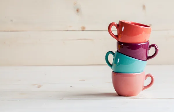Tasses à café colorées sur fond en bois — Photo