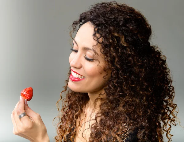 Attractive woman eating strawberry — Stock Photo, Image