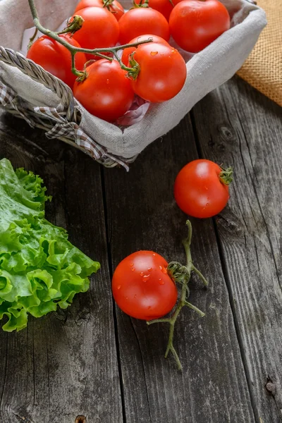 Tomatoes and salad on old grey wood — Stock Photo, Image