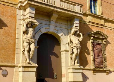 Bolonya 'da bir evin girişindeki erkek heykelleri.