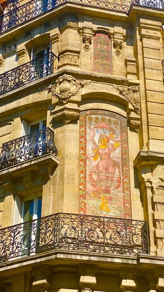 A painted facade of a corner street restaurant in Paris