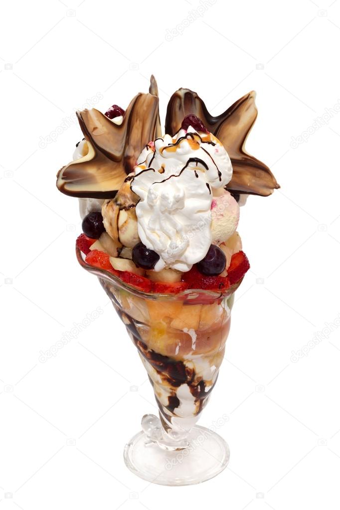 Fruit salad with icecream, cream and topping isolated