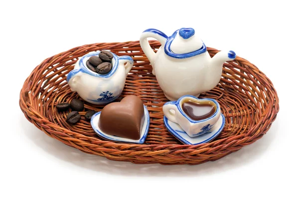 Servicio en miniatura para café, granos de café y corazones de chocolate en una bandeja de mimbre aislada —  Fotos de Stock