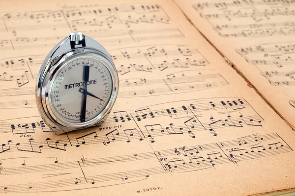 Metrônomo de bolso em uma partitura de música antiga — Fotografia de Stock