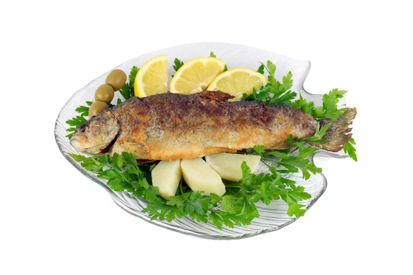 Roasted trout on the fish plate with parsley, lemon, potato and olives isolated on white — Stock Photo, Image
