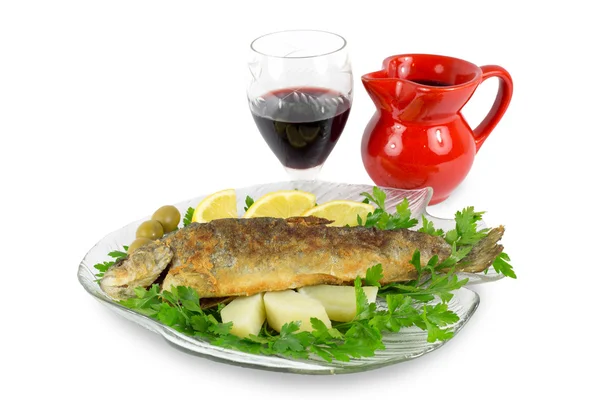 Roasted trout on the fish plate with parsley, lemon, potato, olives and wine isolated on white — Stock Photo, Image