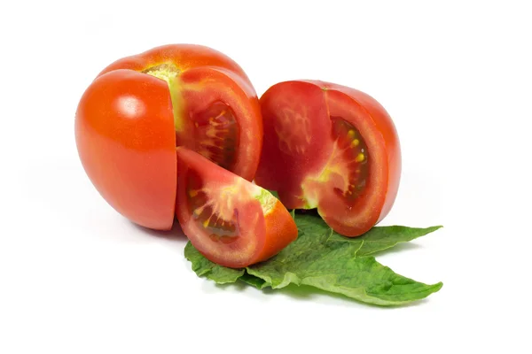 Sliced fresh red tomatoes on green leaves isolated on white — Stock Photo, Image