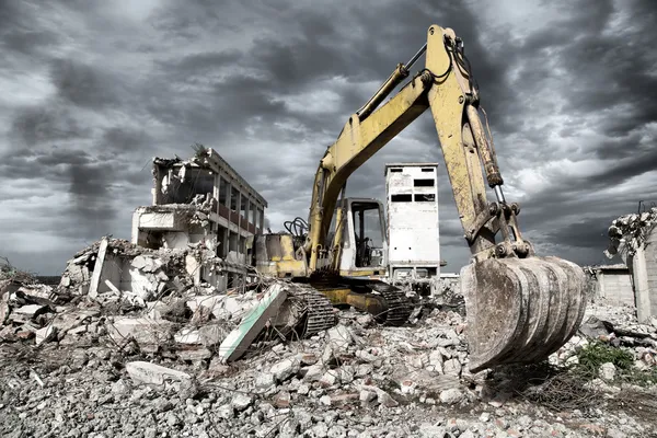 Bulldozer remove os detritos da demolição de antigos edifícios abandonados — Fotografia de Stock