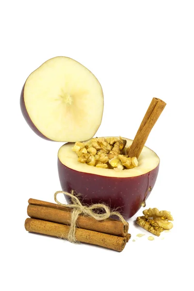 Fresh red apple filled with walnut, honey and cinnamon isolated on white — Stock Photo, Image