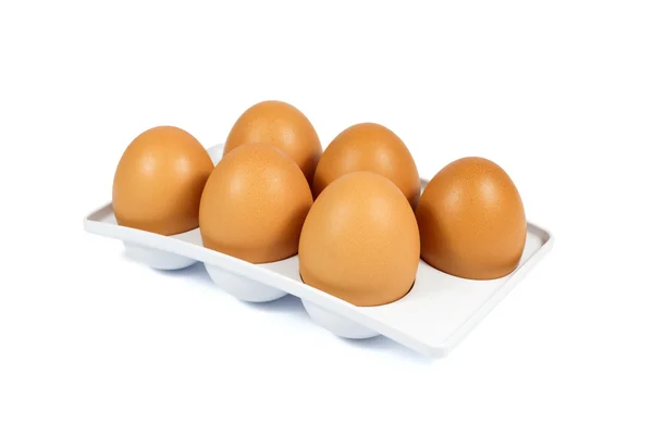 Six Brown Eggs in a White Plastic Package Isolated on White — Stock Photo, Image