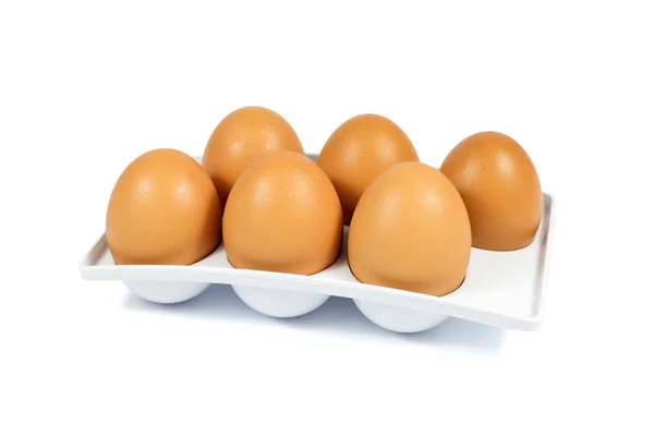 Six Brown Eggs in a White Plastic Package Isolated on White — Stock Photo, Image