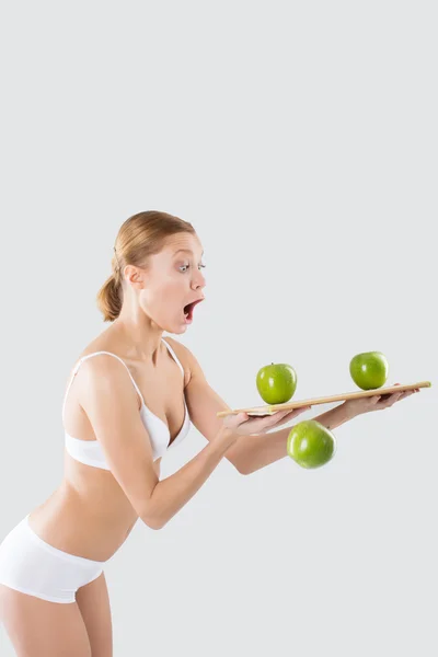 Fitness young woman in lingerie holding a green apple — Stock Photo, Image
