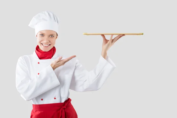 Cook holds in one hand a wooden tray — Stock Photo, Image