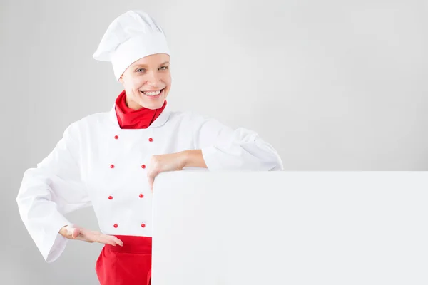 Girl dressed as chef hands holding white banner — Stock Photo, Image