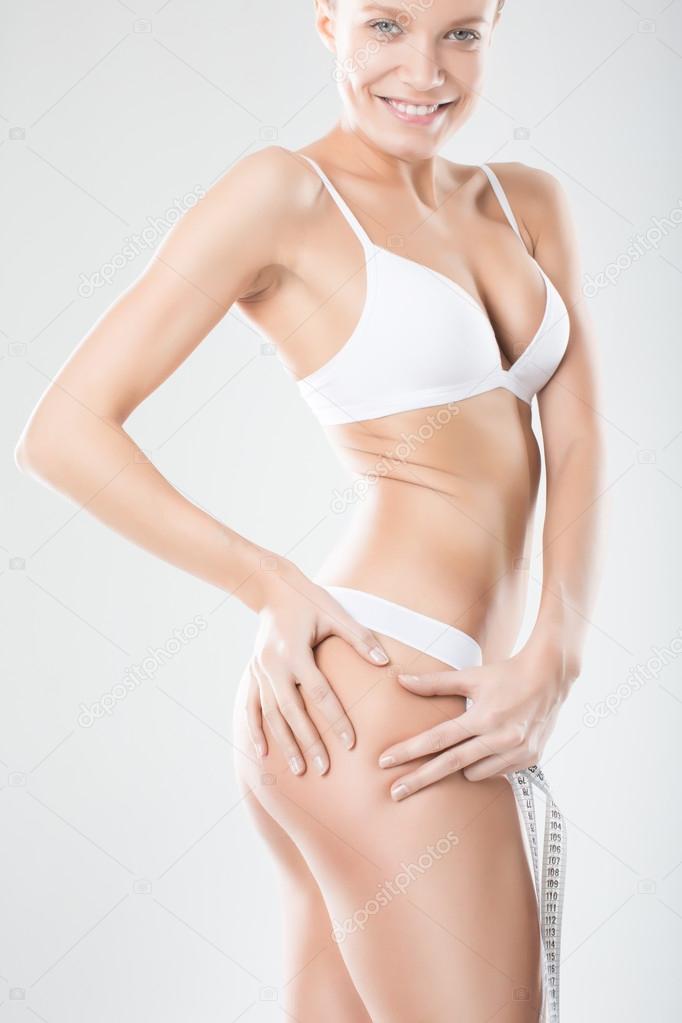 pretty woman buttocks without cellulite on white background