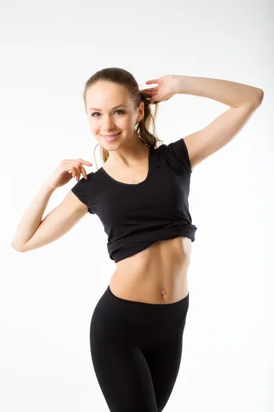 Young sexy athletic woman in black sportswear - isolated on whit — Stock Photo, Image