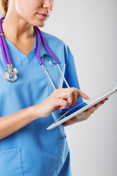 beautiful young female medical intern with tablet computer