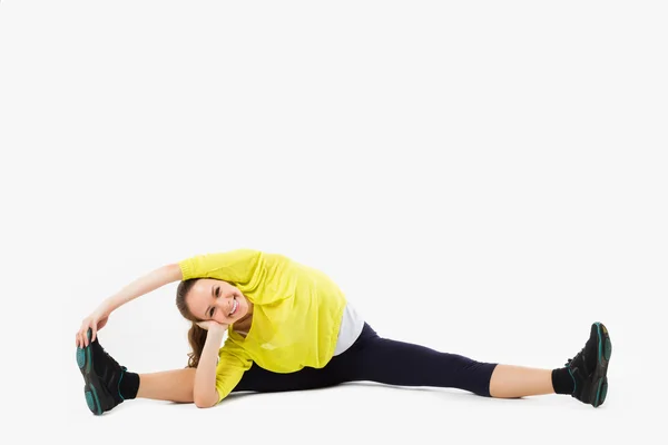 Split. Young woman doing stretching exercise. Isolated on white — Stock Photo, Image