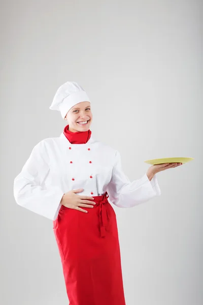 Chefe a mostrar o prato vazio. Feliz sorrindo retrato de fêmea em ch — Fotografia de Stock