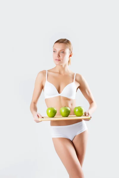 Schöne sportliche Frau mit grünem Apfel — Stockfoto