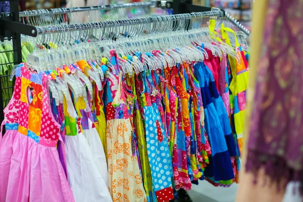 A rack of colorful shirts hanged for sale at a fair — Stock Photo, Image