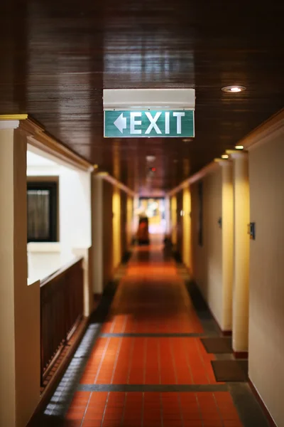 Exit sign on the wall — Stock Photo, Image