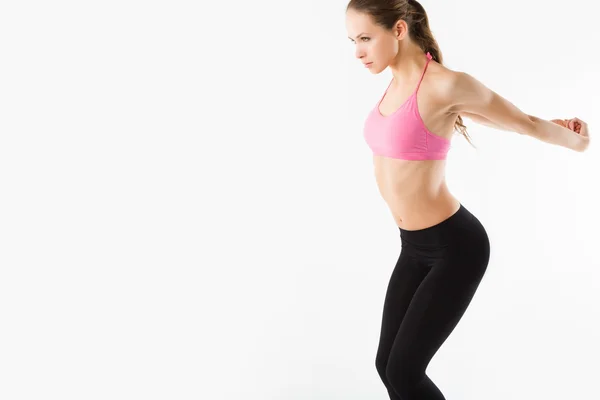 Studio portrait of cute young fitness girl doing yoga exercises. — Stock Photo, Image