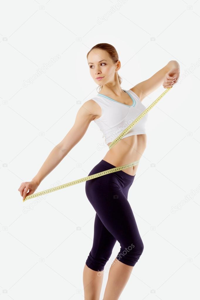 a girl measuring waist