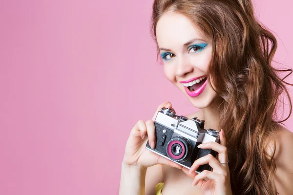 Beautiful model with a camera — Stock Photo, Image