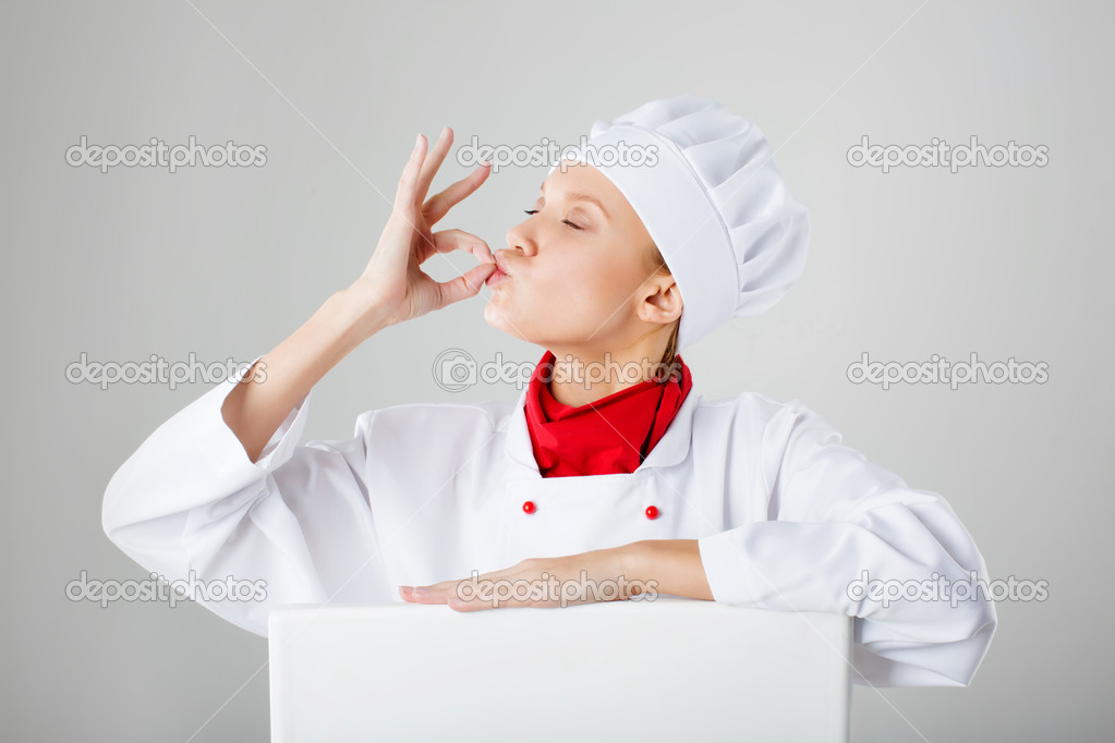 Woman chef cook making okay gesture with his hands after tasteful meal