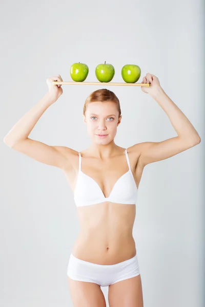 Young slim girl holding a green apple — Stock Photo, Image