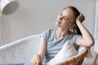 Happy smiling woman stress free. Close-up portrait of a cute girl with closed eyes, calm lifestyle.