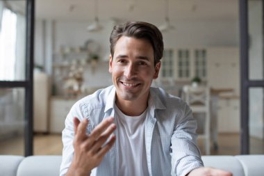 Portrait of young man talk speak on video call with friends or relatives, making video call. Online communication concept.
