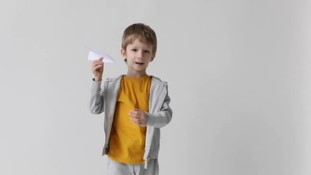 かわいい男の子は紙飛行機を起動し 家で遊ぶ — ストック動画