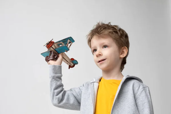 Smiling Cute Boy Wooden Plane His Hands Dreaming White Background — Stock Photo, Image