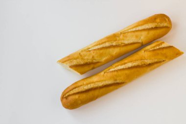 Ekmek beyaz yüzeyde ikiye bölünmüş ve kopyalanmış.