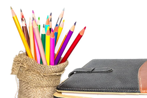 Colour pencils and notebook on white background — Stock Photo, Image