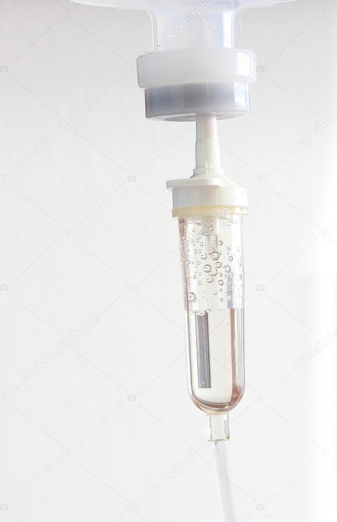 Infusion bottle with IV solution on white background