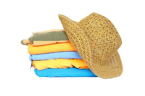 Pile of colorful clothes with a hat over white background — Stock Photo, Image