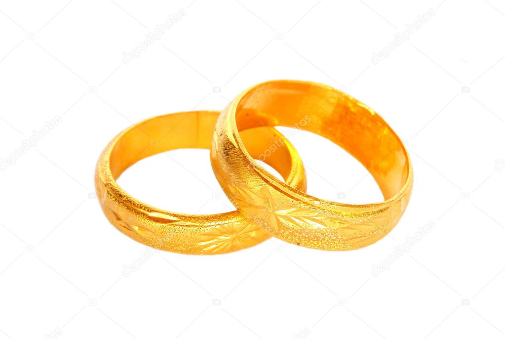 couple of gold wedding rings on white background 