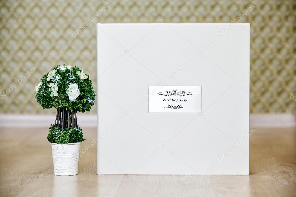 Box for wedding photo album with leather cover and metal shield.