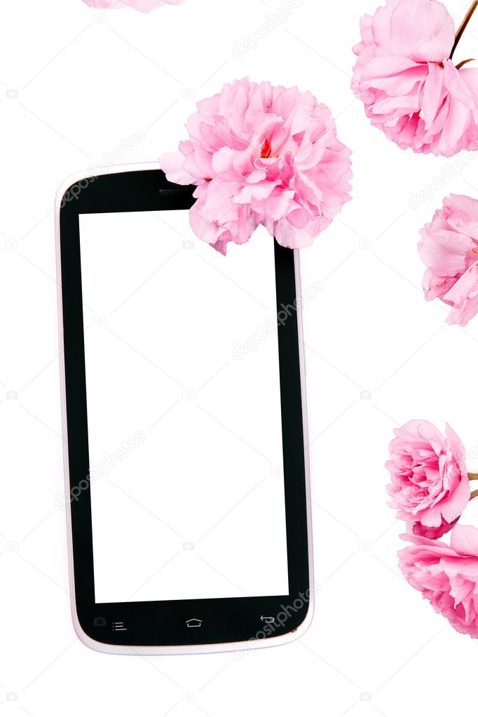 Mobil smart phone surrounded by pink cherry flowers