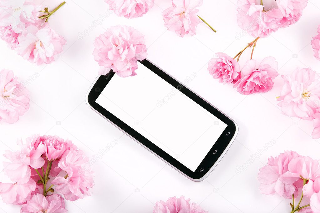 Mobil smart phone surrounded by pink cherry flowers
