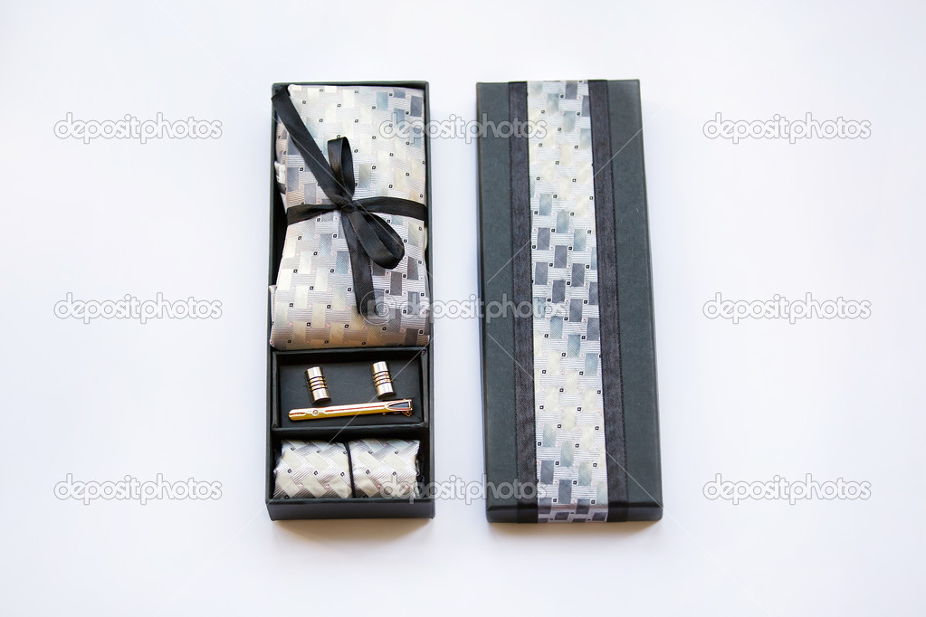 Cufflinks, tie, tie clip, handkerchief in box. Isolated on white