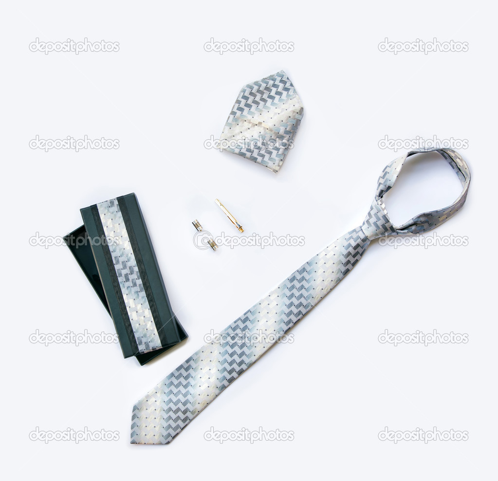Cufflinks, tie and tie clip, handkerchief and box isolated on wh