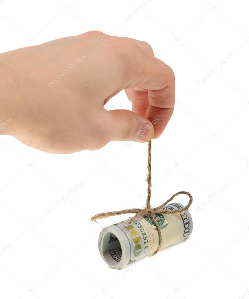 Man s hand holds a roll of dollars isolated on white background