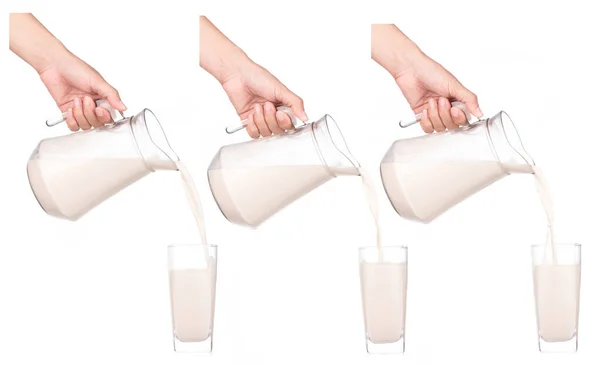 一组手拿着装有牛奶的壶 倒入白色背景隔离的玻璃杯中 — 图库照片