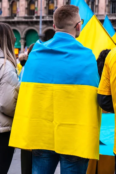 Jovem envolto na bandeira ucraniana em um protesto contra a invasão da Rússia Fotos De Bancos De Imagens
